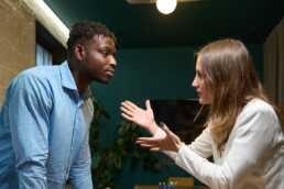 two people in discussion one with their hands out gesturing by way of explanation
