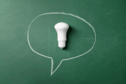A light bulb in a speech quote on a green background