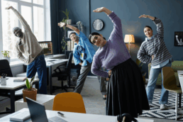 A group of business people stretching in the office